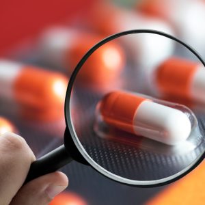 A magnifying glass over pills