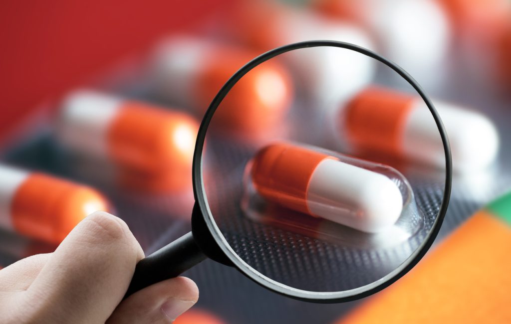 A magnifying glass over pills